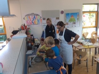 Das Bild zeigt Kinder und Erzieherinnen der Kita "Die kleinen Strolche" in der Küche