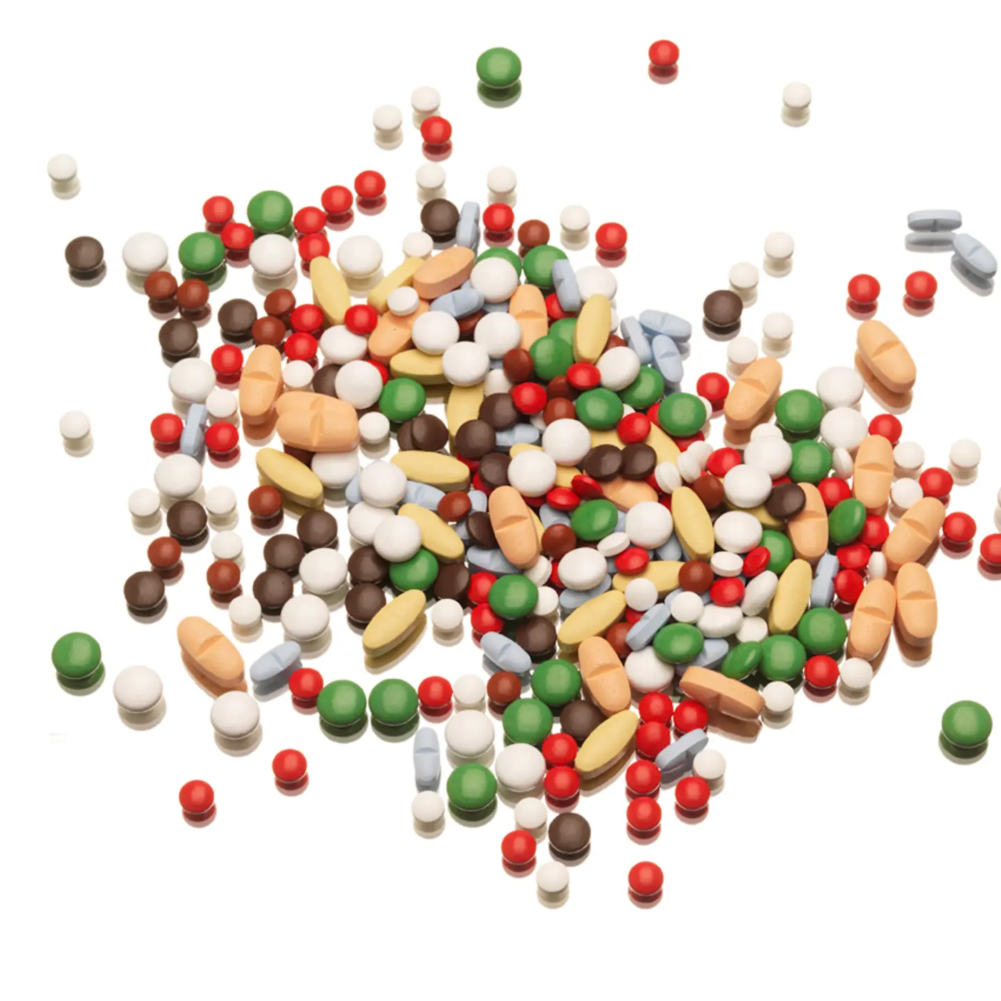 Viele farbige Tabletten liegen auf einem Haufen auf einem Tisch