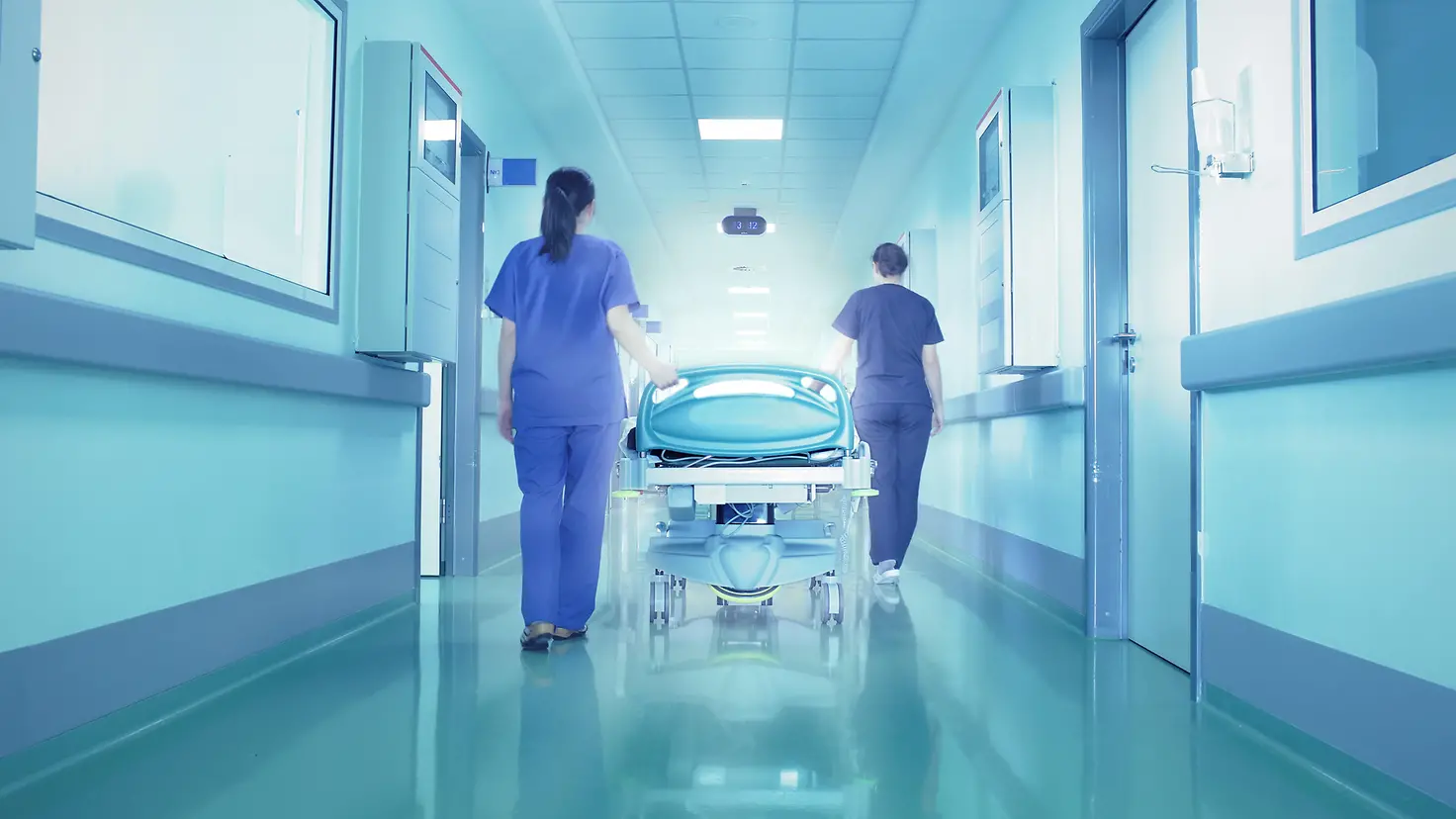 Das Bild zeigt zwei Mitarbeitende eines Krankenhauses.