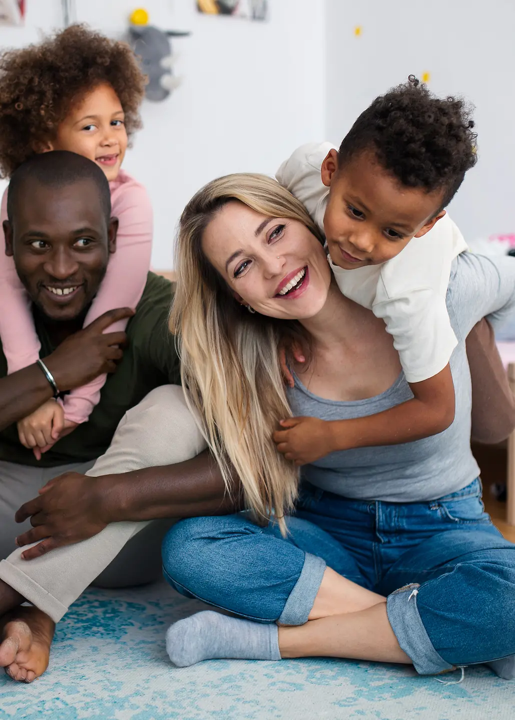 Happy multiracial family playing with airplanes toys at home