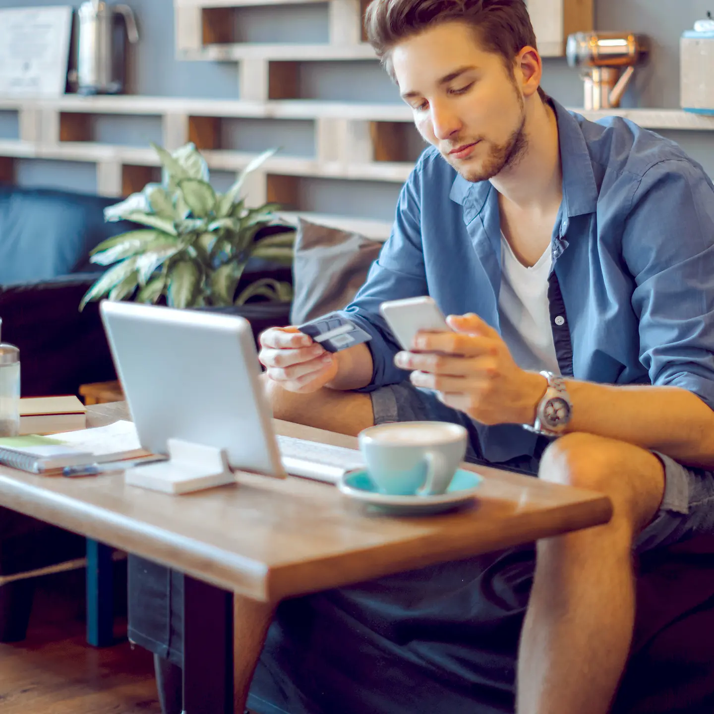 A young man at home with an Electronic Health Insurance Card