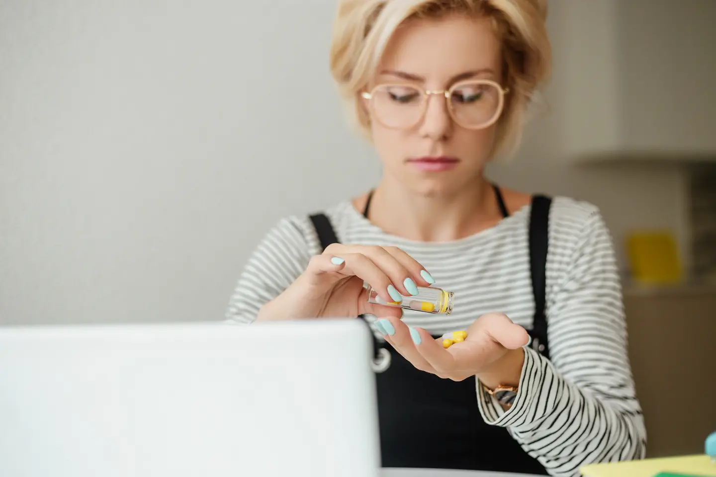 Eine junge Frau nimmt ein Nahrungsergänzungsmittel ein