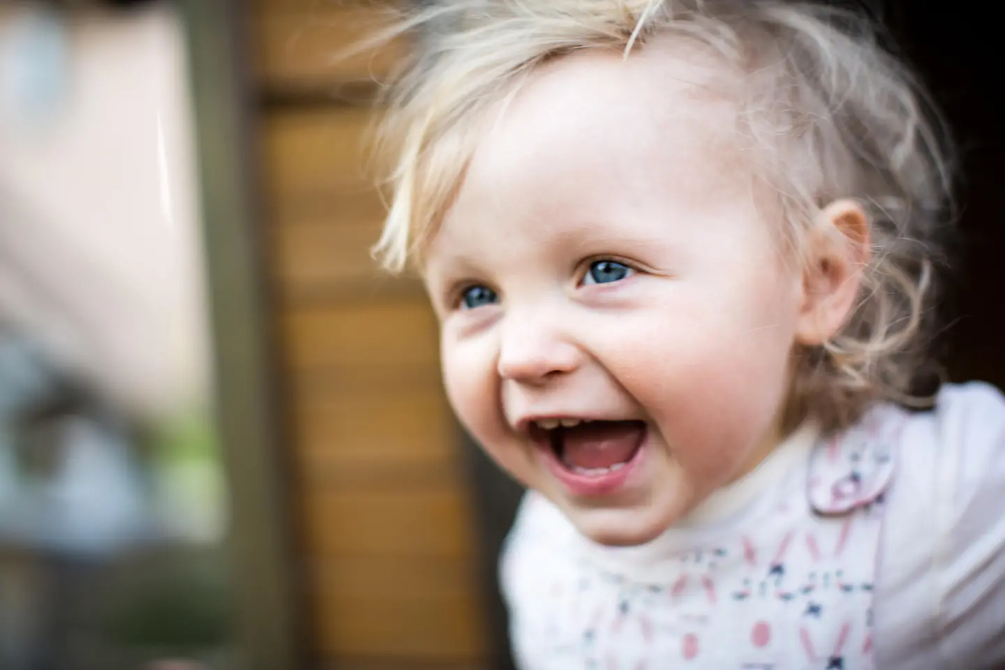 Zu sehen ist ein lachendes Kind