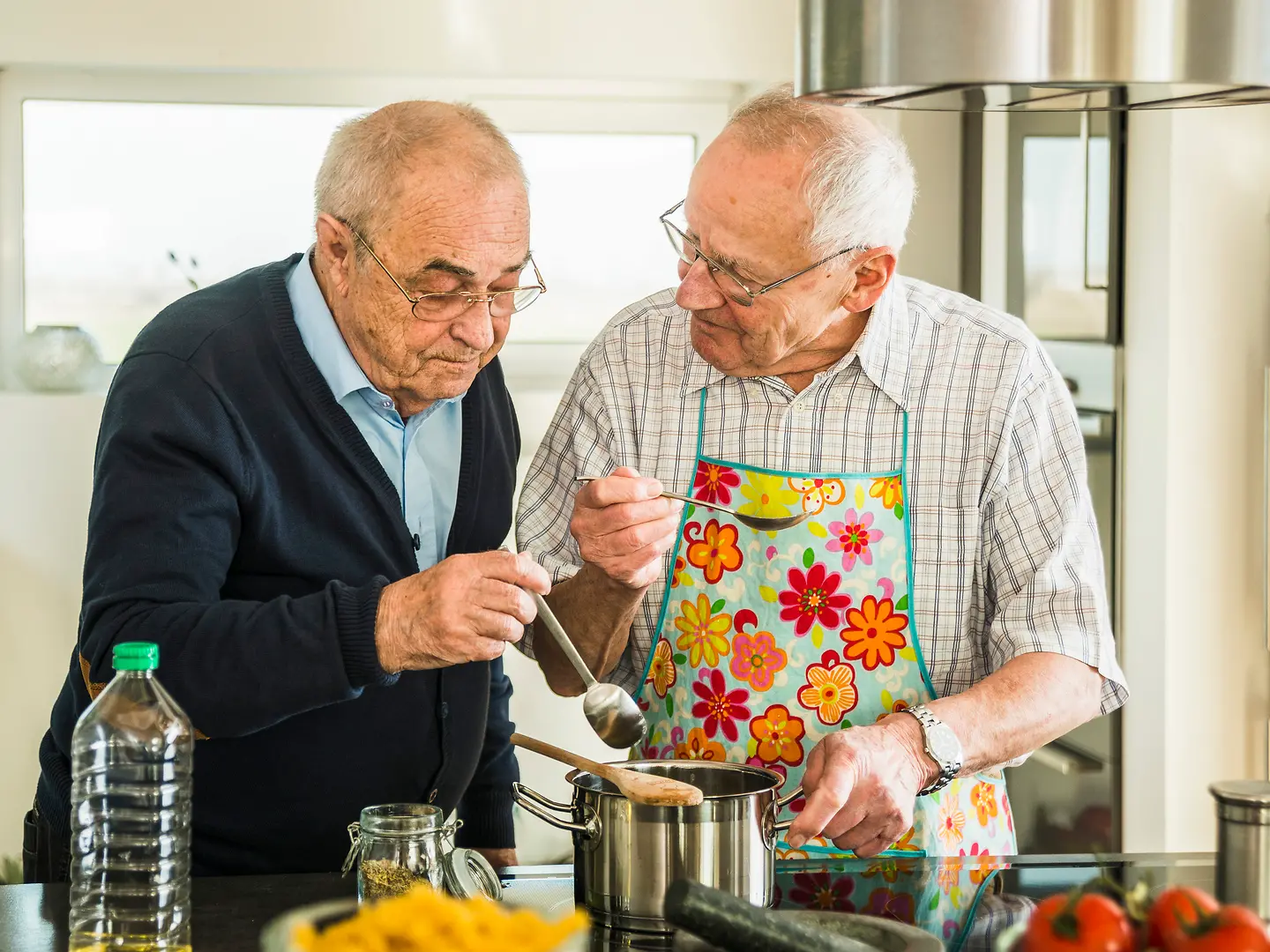 Zu sehen sind zwei ältere Herren beim Kochen 