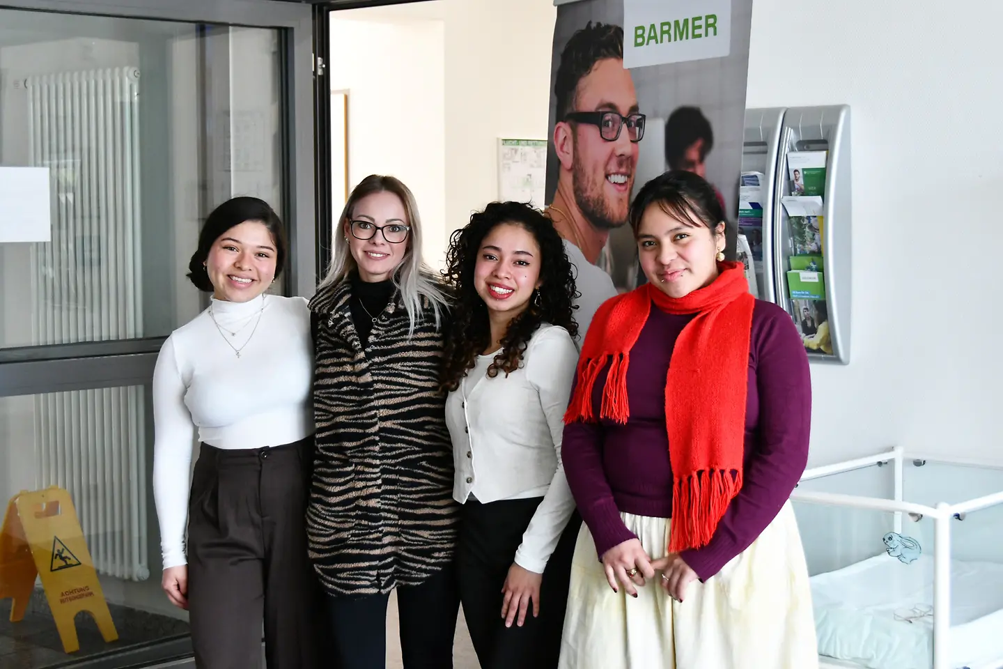 Drei junge Frauen aus El Salvador mit Barmer-Mitarbeiterin Melanie Noka.