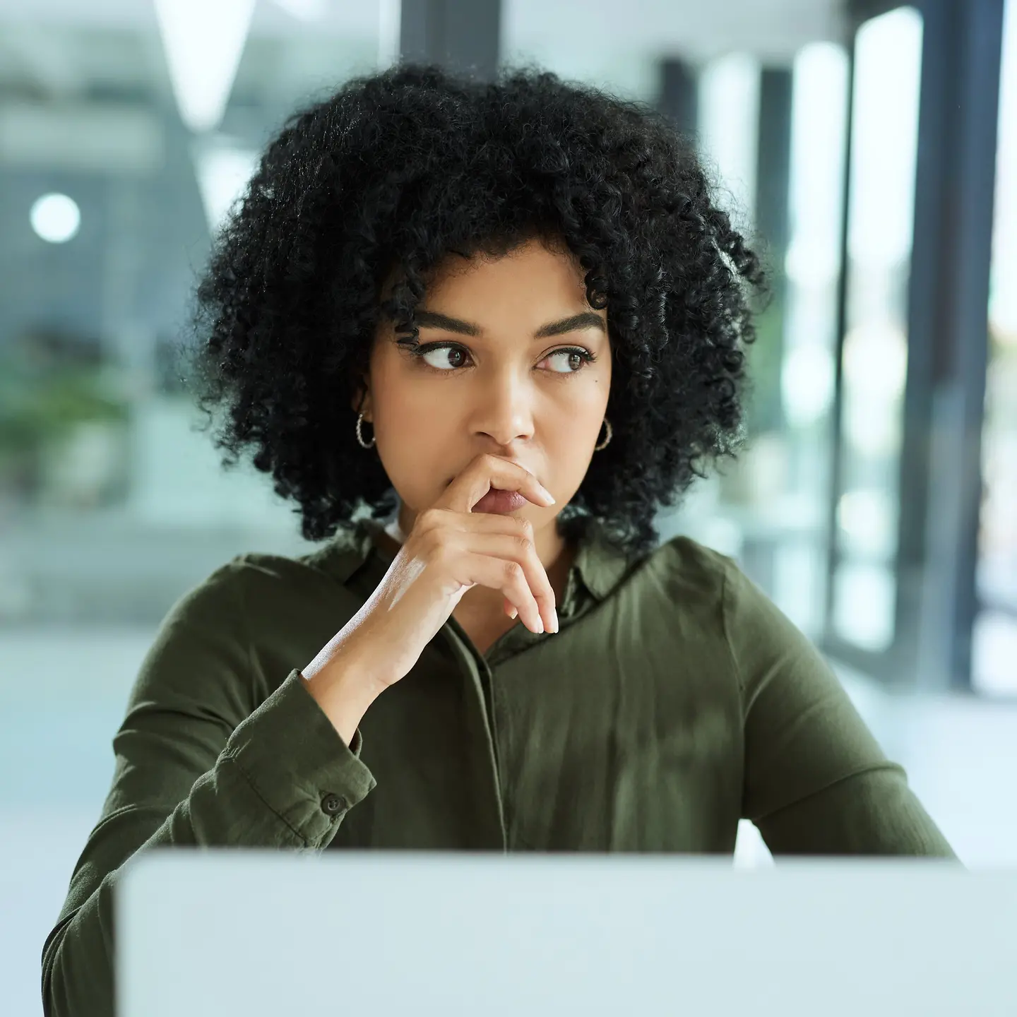 Junge Frau an ihrem Laptop in einem modernen Büro